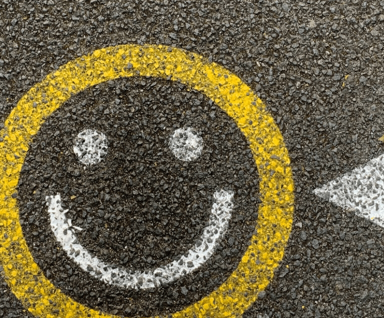 Smiley face on tarmac road