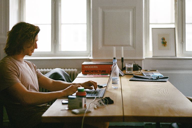 man working on laptop at home