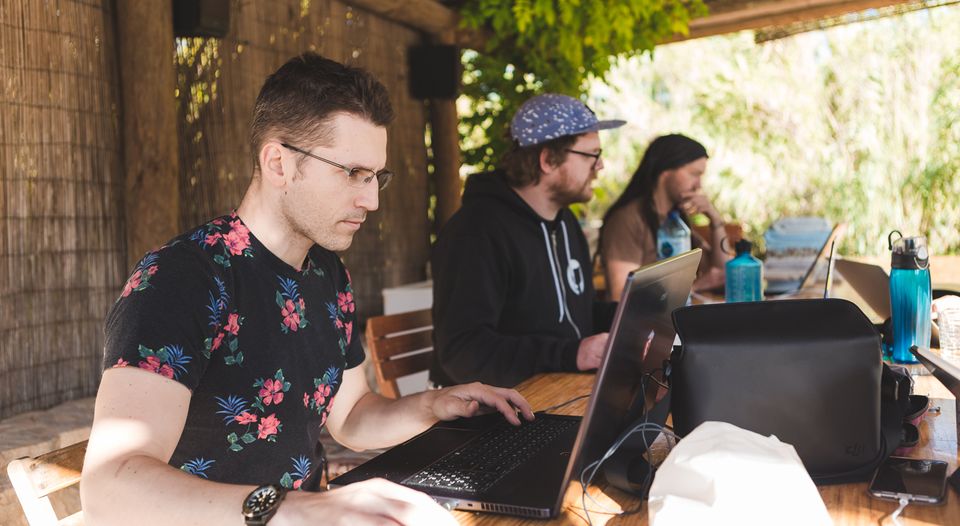 Henry, James and Simon on laptops outside