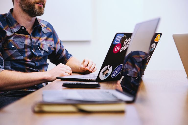 Software developer sitting with laptop