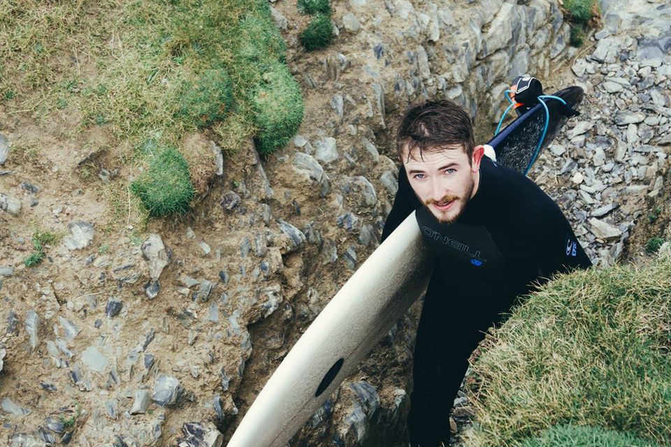 Sam with a surfboard